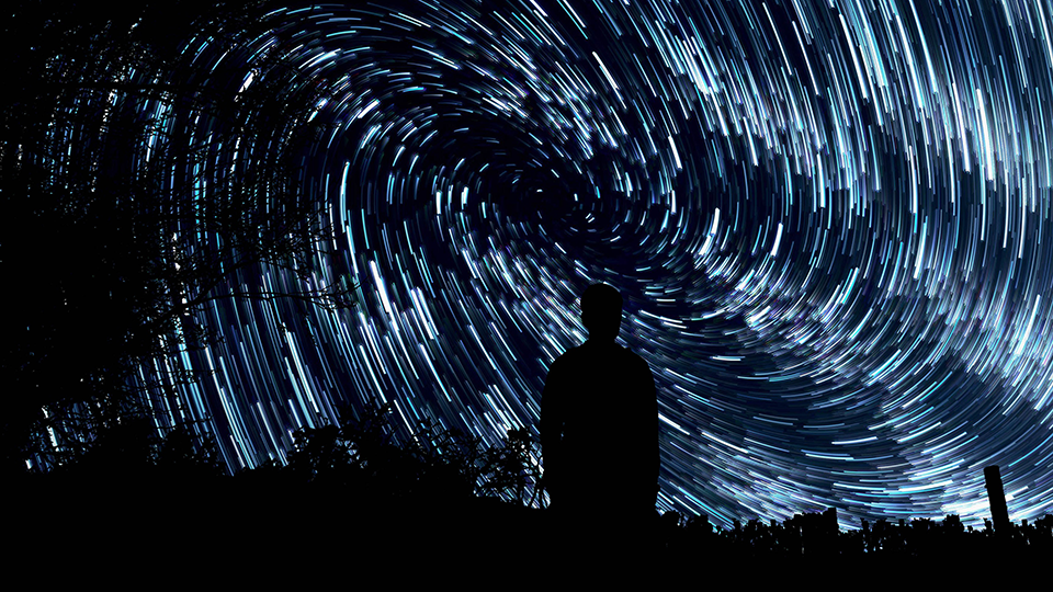 Person admiring an Omnitheater image of the galaxy. 