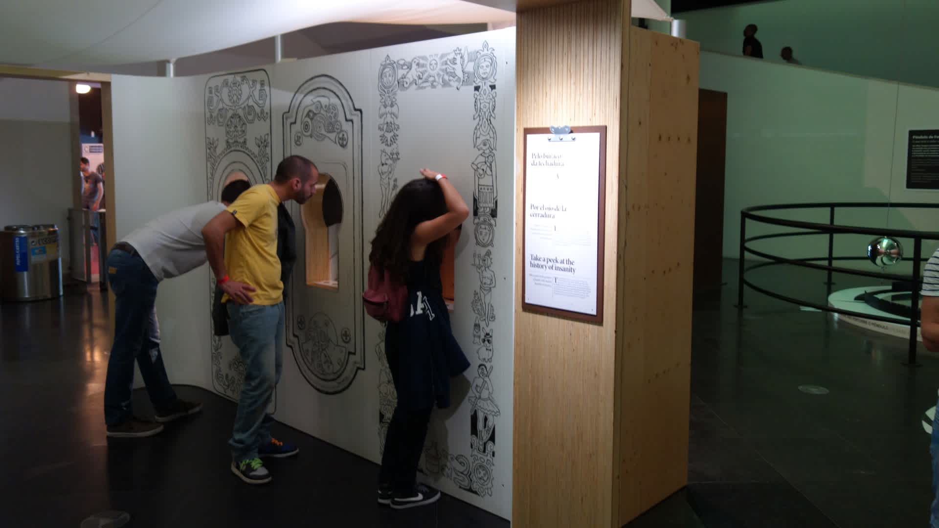 Image of 3 individuals in the Mind Matters exhibit looking into mirrors (part of the exhibit) 