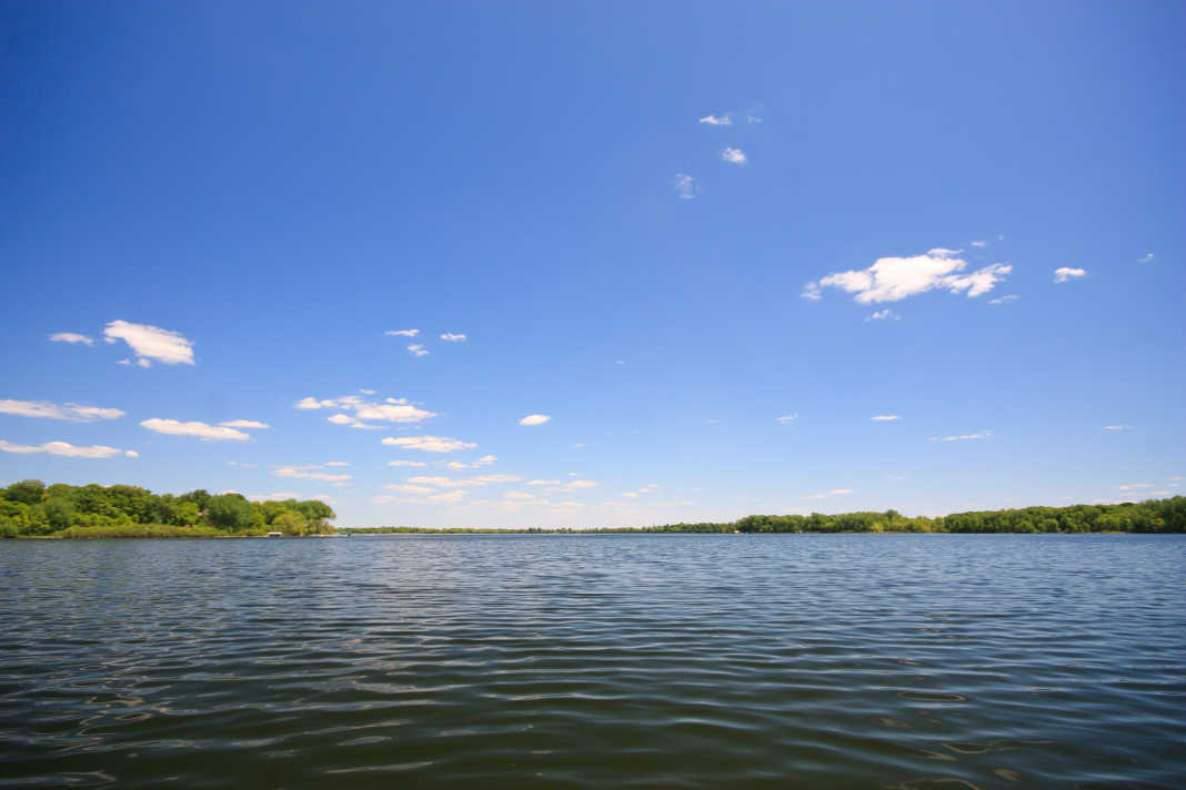Madison Lake, Minnesota: a light green lake with a blue sky