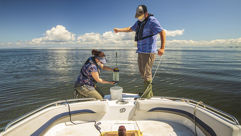 Science Museum of Minnesota scientists Adam Heathcote and Alaina Fedie collecting water samples.