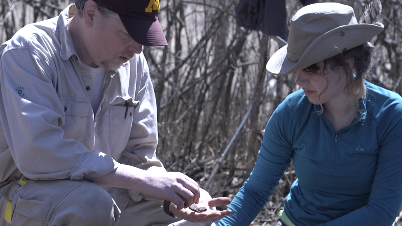 Two scientists comparing rocks