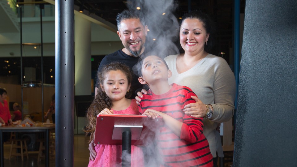 Family playing with indoor tornado