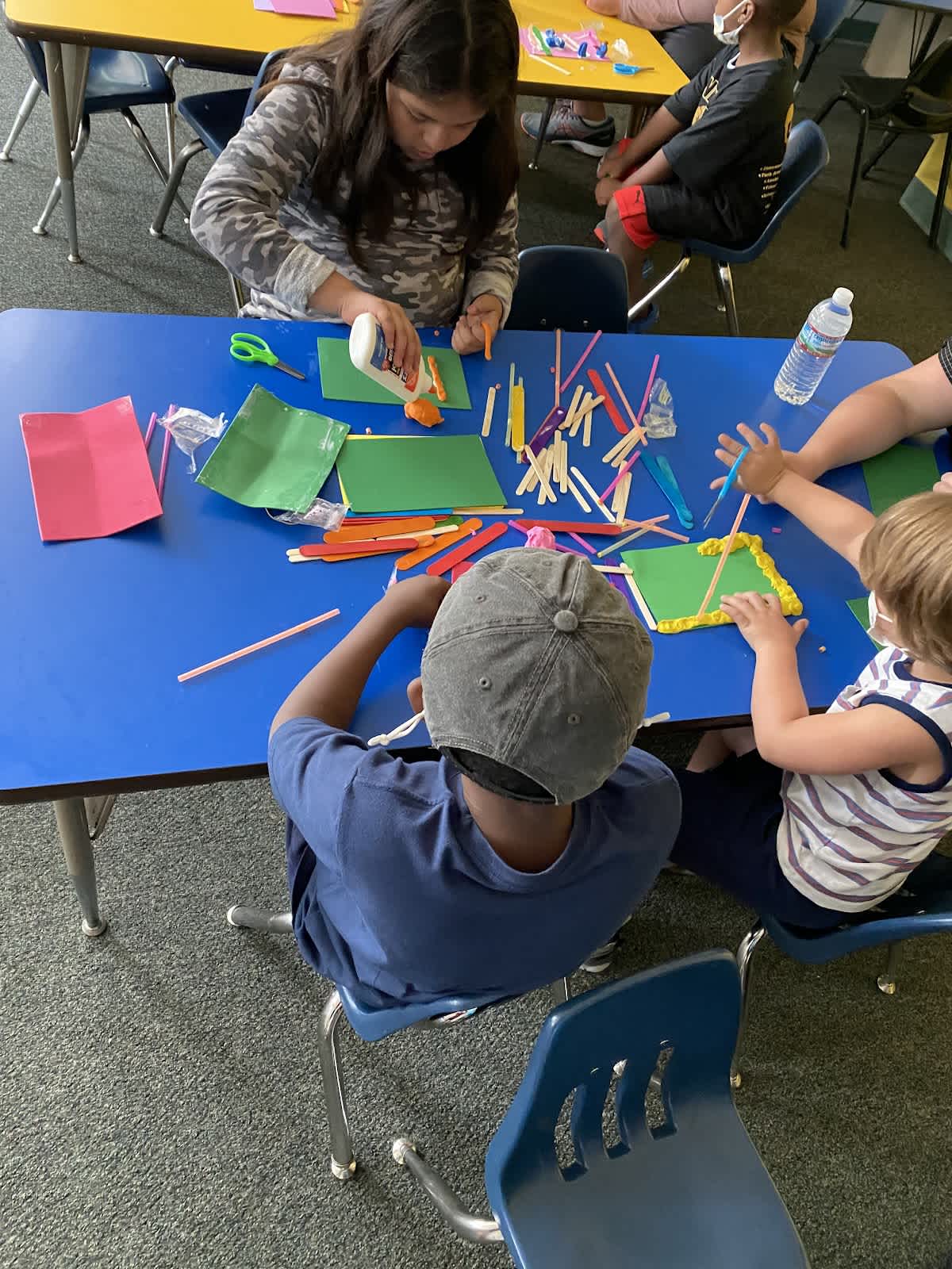 A photo from above as a group of Freedom School students working at a table on an activity.