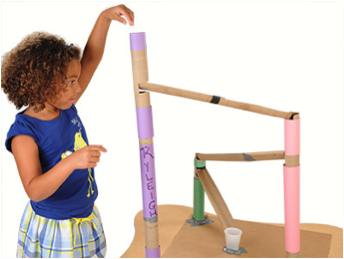 Girl engineering a cardboard structure