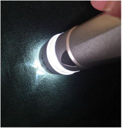 Flashlight beam next to a surface 