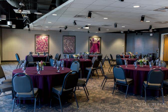 Argon event space decorated for a holiday party with glassware on tables.