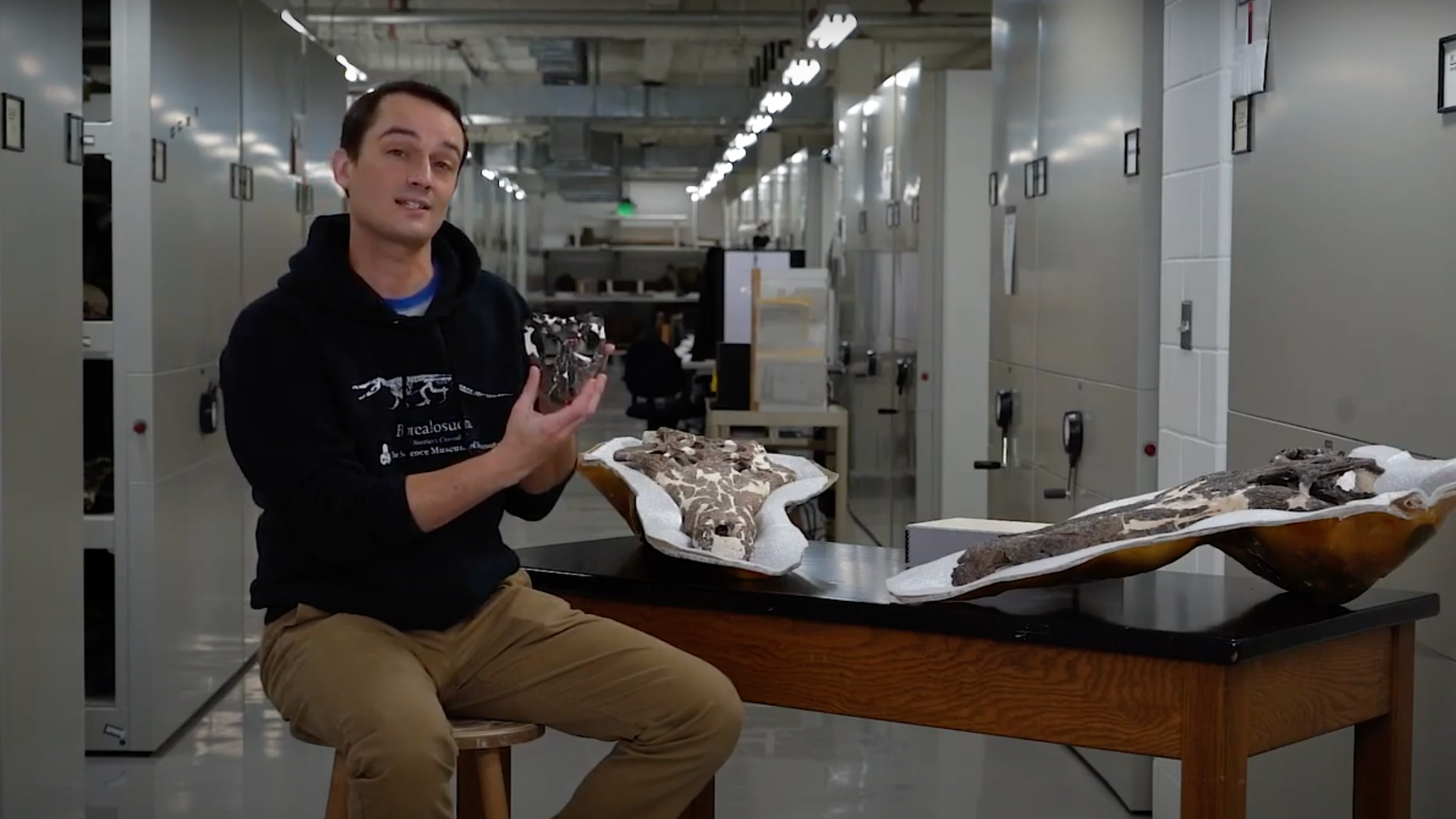 Dr. Alex Hastings showing croc fossils in crocs around town