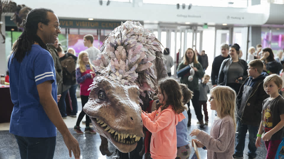 Kids playing with the walking T. rex dinosaur puppet