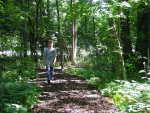 A student walking on the completed nature trail