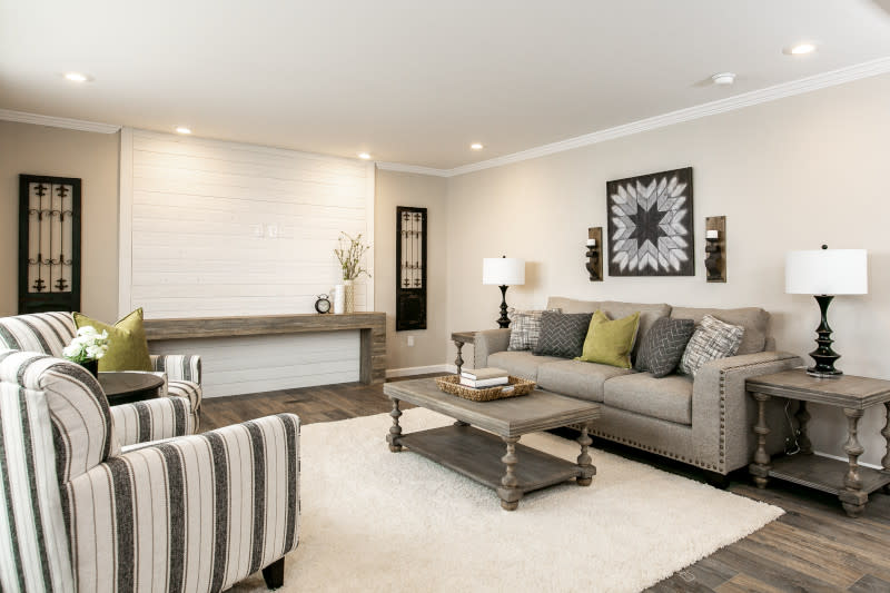 Manufactured home living room with a built-in entertainment center and beige walls.