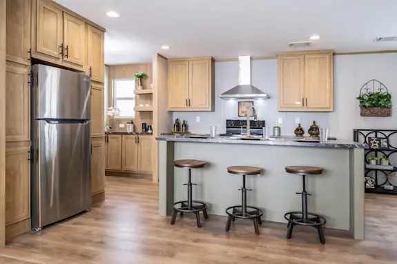 The [model name] features a beautiful kitchen with stainless steel appliances and a coffee bar.