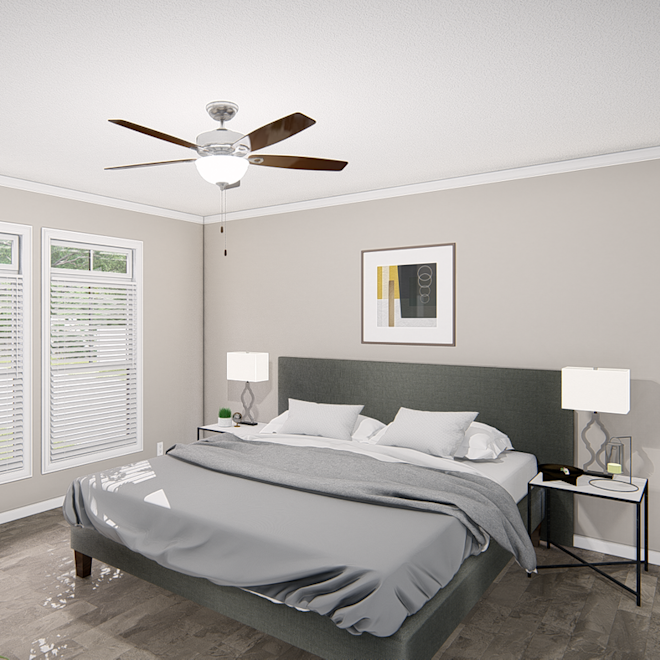 The primary bedroom of The Riviera features beautiful wood-style floors and large windows.