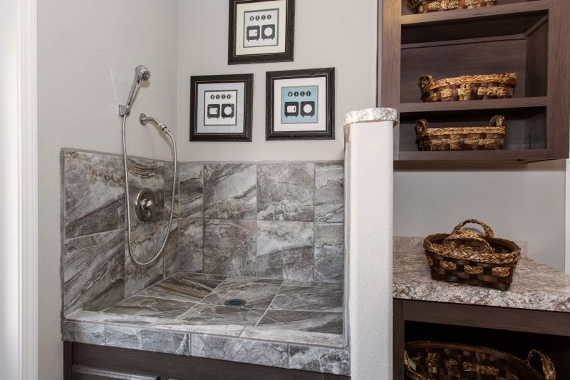 A mudroom with a pet grooming station.