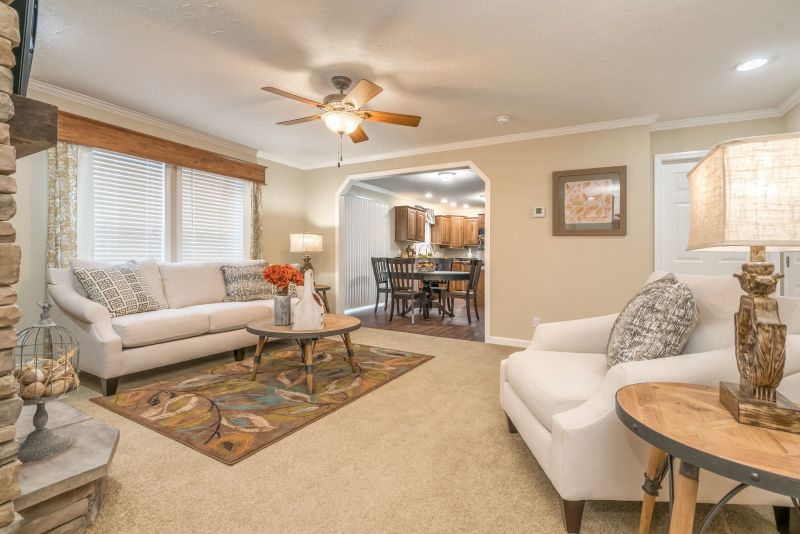 Living room with white couches and arched doorway