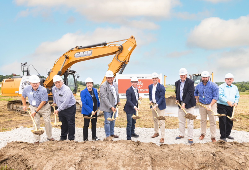 10 people holding shovels for a new neighborhood groundbreaking. 