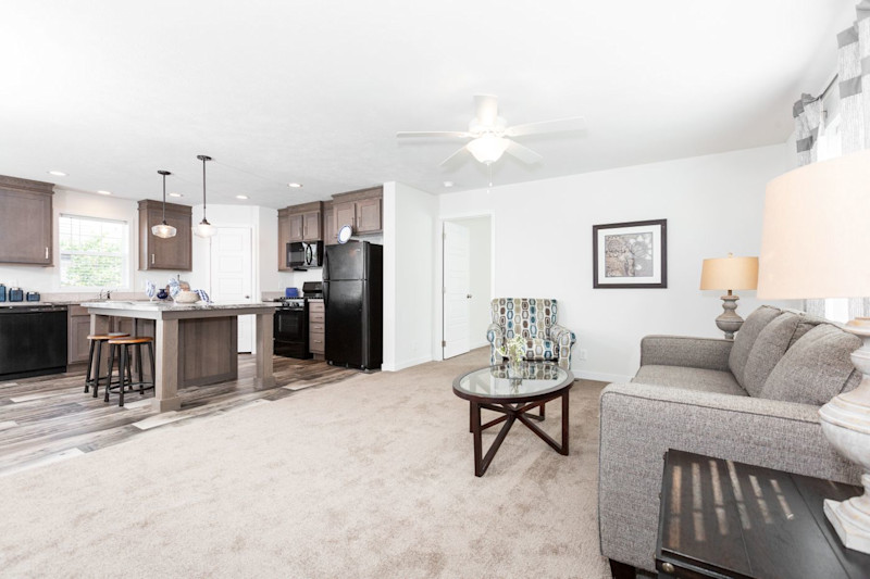 The open living room and kitchen of the Somerset manufactured home model.