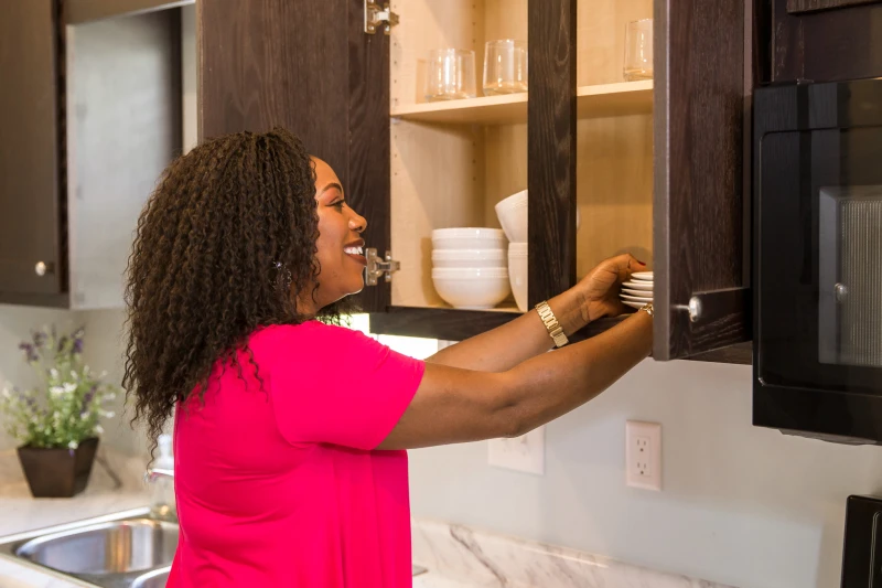 woman putting away dishes