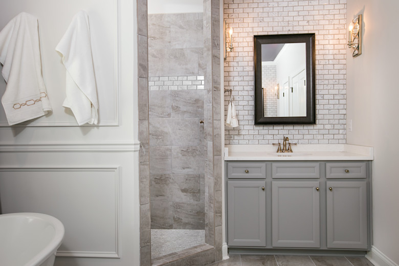 Manufactured home bathroom with copper accents and a marble shower.