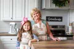 Women and young girl in the kitchen of their manufactured home.