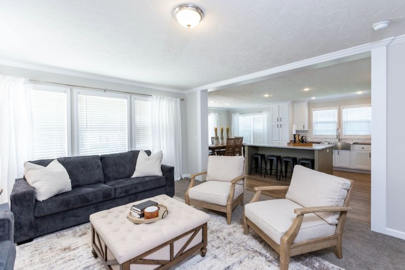 living area that features a large entry way, crown molding, and big picture windows