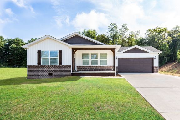 Nothing feels better than coming home to this front porch with wood beam and brick detailing in the Keeneland.