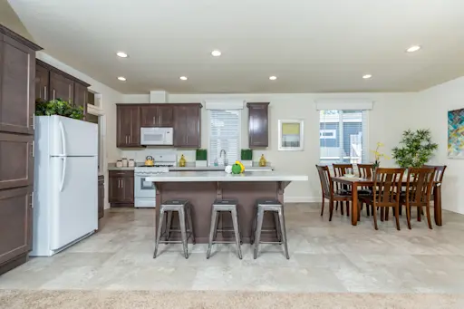 The Fairpoint 24623A features a spacious kitchen island with a breakfast bar and lovely window cornices.