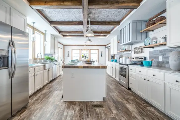 The Emma Jean will make your farmhouse dreams come true with its stunning kitchen features like a walk-in pantry and open shelving.