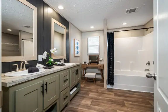 The [model name] features dual sinks and an open corner nook to put a makeup vanity or laundry hampers there.