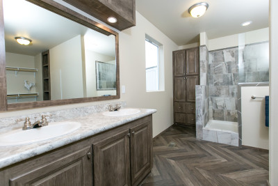 Primary bath with dual vanities, walk-in shower and built-in storage closet