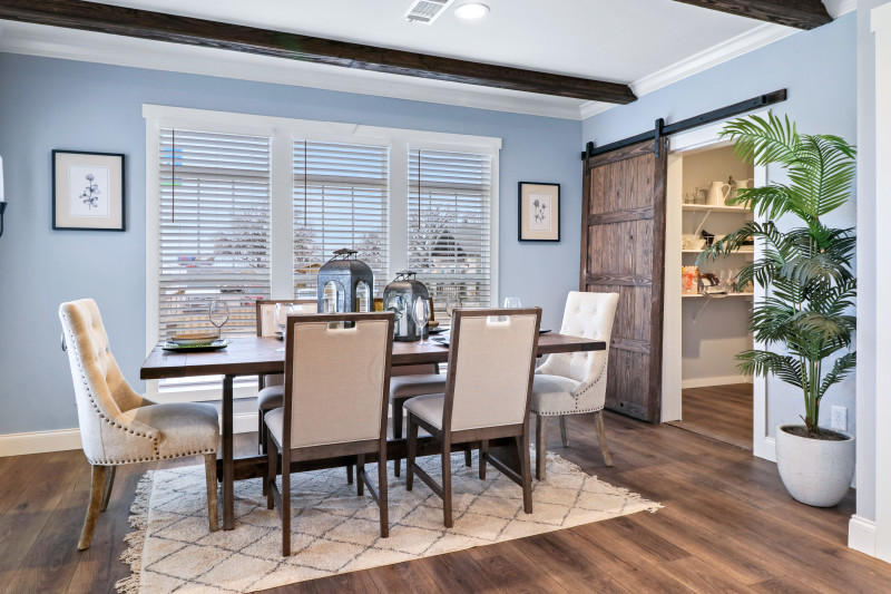 Dining room with table and chairs, barn door in the back