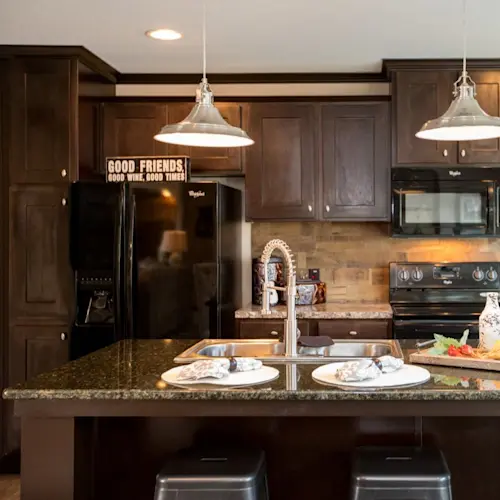 The kitchen in The Washington (Patriot) GW features an island with a built-in sink and lots of storage space.