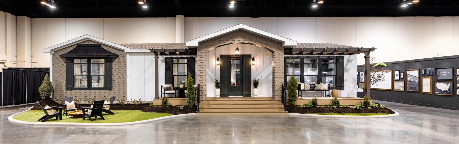 Exterior image of a modern manufactured home with coastal features and an arched entryway. 