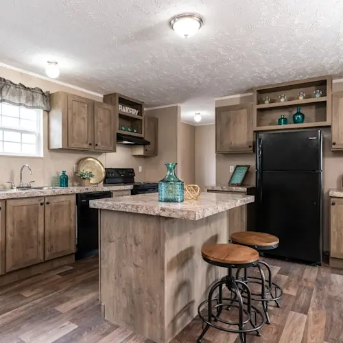 The kitchen in The Eagle 60 features a kitchen island and quartz-style counters.
