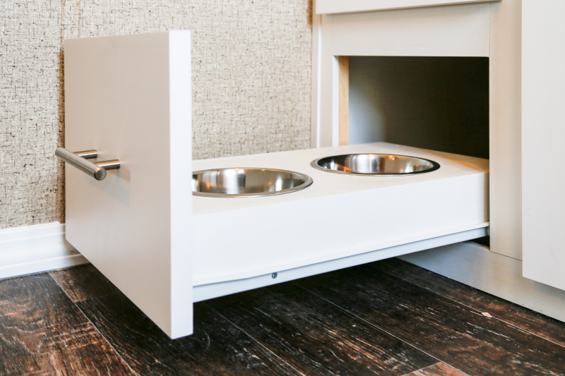 Hideaway pet food dishes in white cabinetry