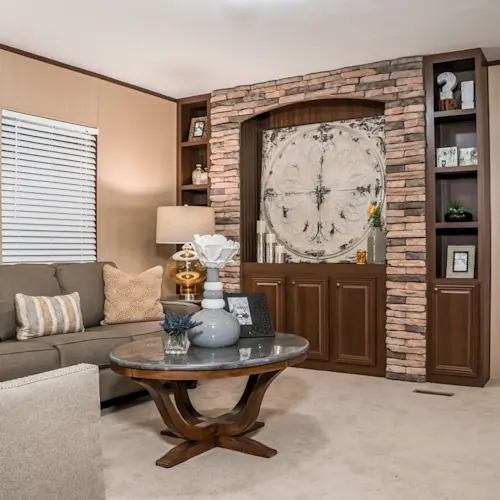 The Choice's living room features a custom, built-in entertainment display with beautiful stacked stone accents, open shelving and closed cabinet storage.