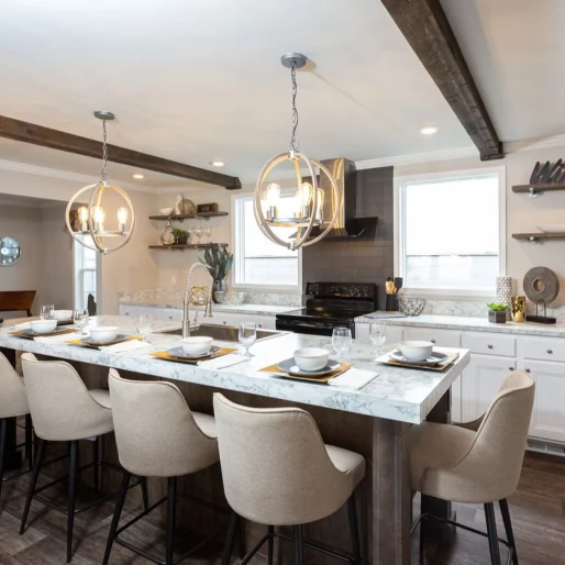 The kitchen in [model name] features long quartz-style countertops and beautiful ceiling beams.
