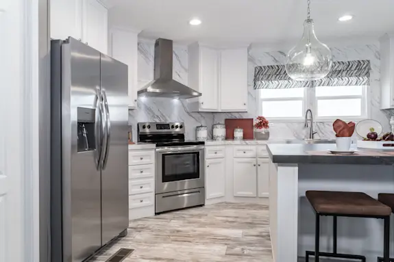 The [model name] features elegant design details and a kitchen with continuous marble-style countertops and stainless steel appliances.