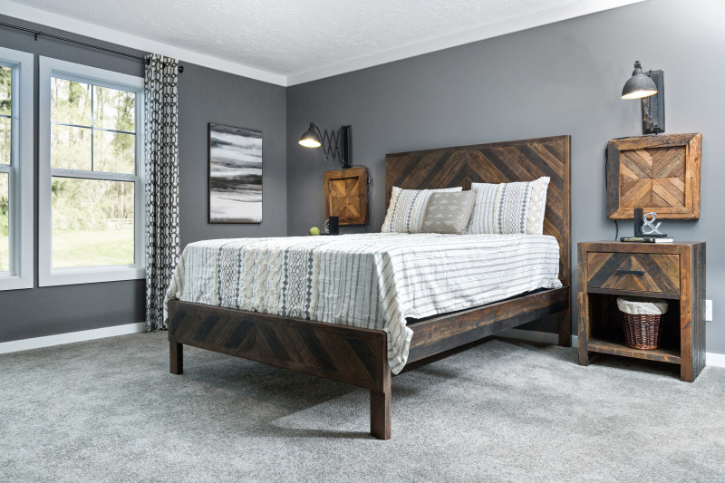 master bedroom with gray walls and rustic wood furniture