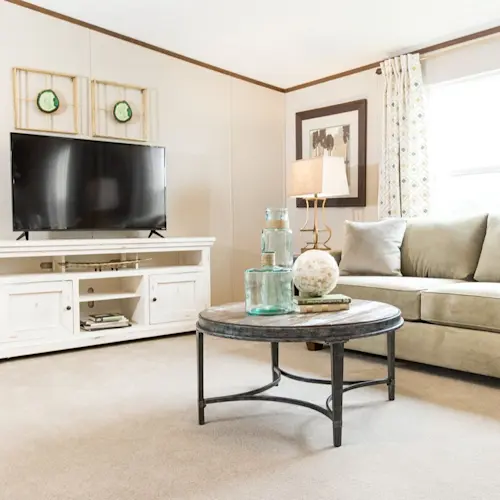The Pride living room is a showstopper with a beautiful, neutral color pallet and wood style trim. 