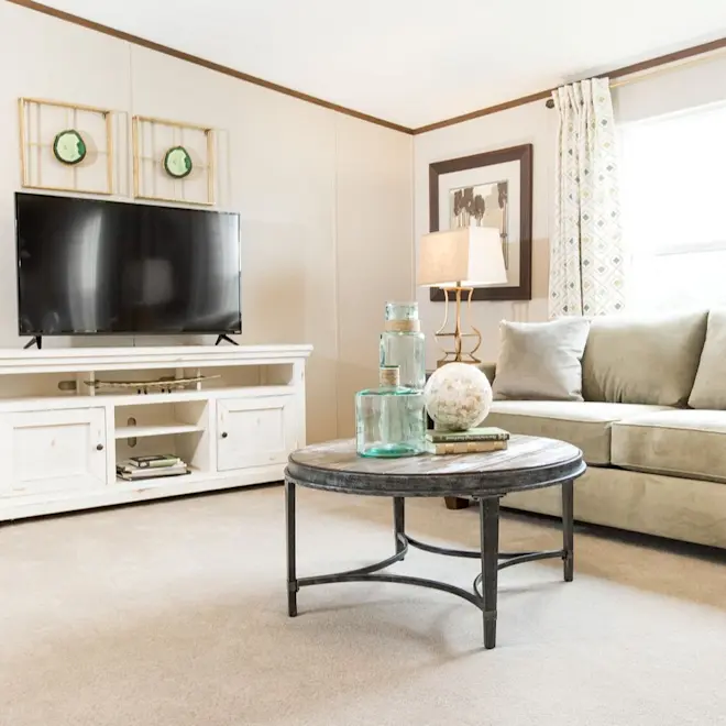 The Pride living room is a showstopper with a beautiful, neutral color pallet and wood style trim. 