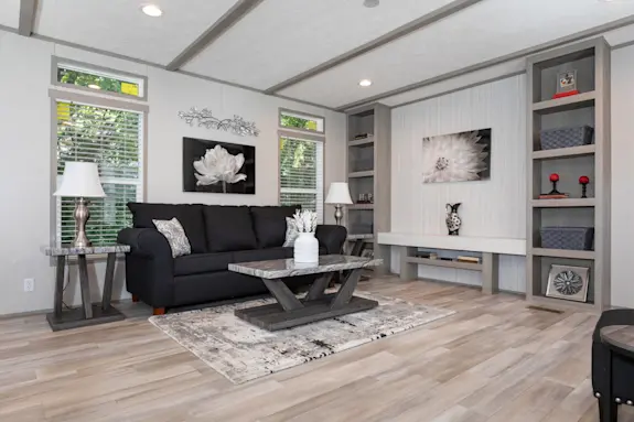 The Anniversary 16763A features a built-in entertainment center with shelving and ceiling beams.
