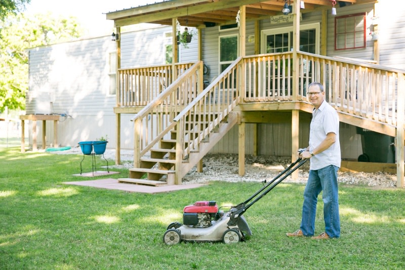 A man mowing his yard