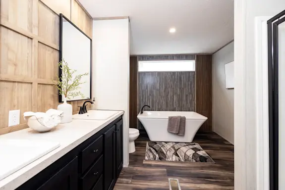 The [model name] features a chic soaker tub and two accent walls.