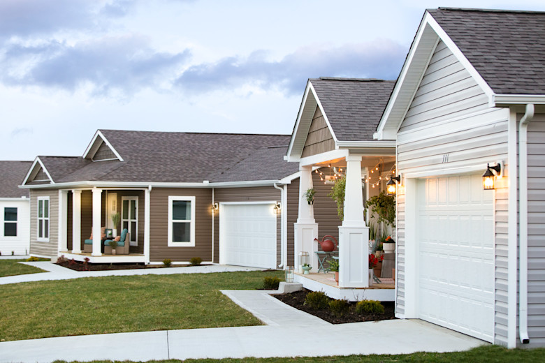 Outside of a Clayton Built® home neighborhood with green grass.