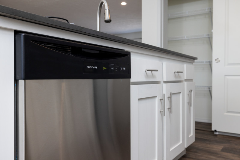 Close-up of a black and stainless steel dishwasher in the kitchen island of a Clayton manufactured home