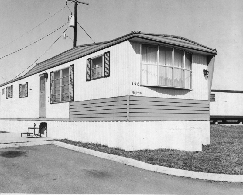 Black and white photo of an old mobile home.