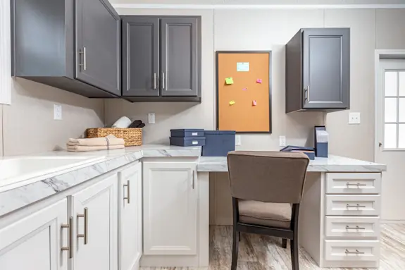 The [model name] multitasks with a utility room that also flexes as an office nook.