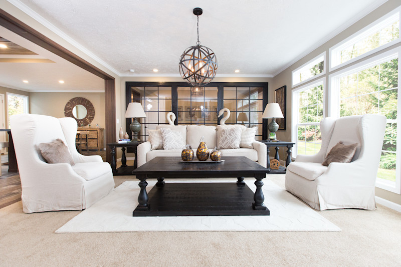 The Churchill home model with a large glass window behind a kitchen table.