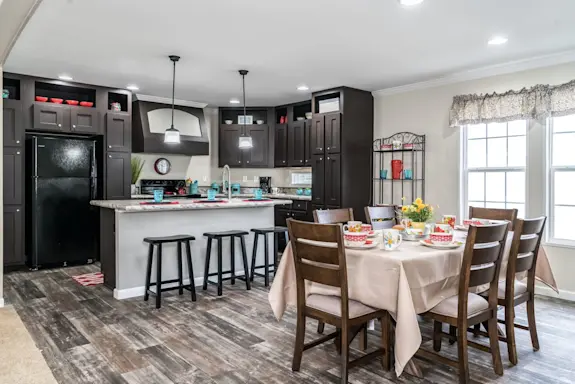 Dark cabinets, crown molding, decorative hood range and beautiful countertops are just a sneak peak of what makes The Freedom XL 3276 4BR a top choice for larger homes.