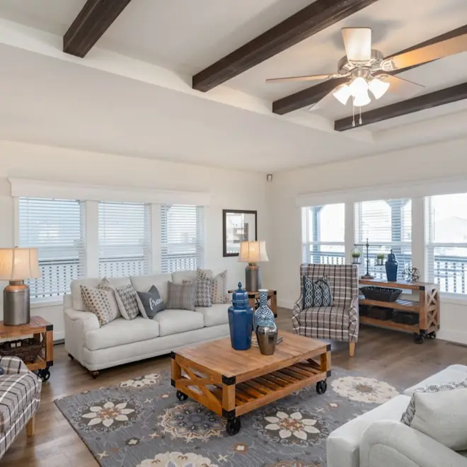 The living room of Coronado 3760A is the place to gather. It's open and airy with large windows and inset ceiling beams.
